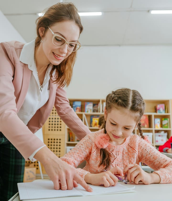 Teacher guiding a student through an interactive activity