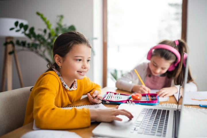 Parent and child reviewing homework progress together
